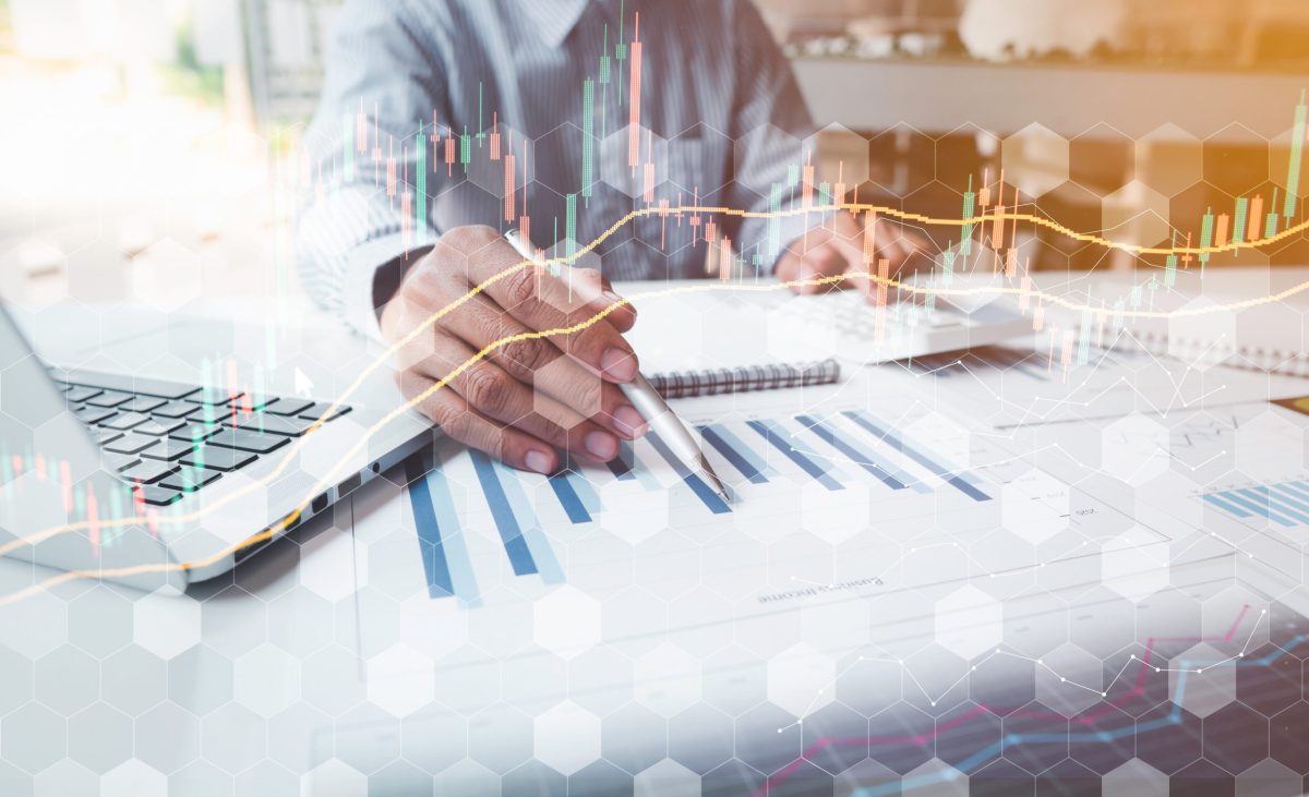 Businessmen or stock analysts are analyzing stock market trading graphs with stock chart data, financial investments, business and technology ideas.